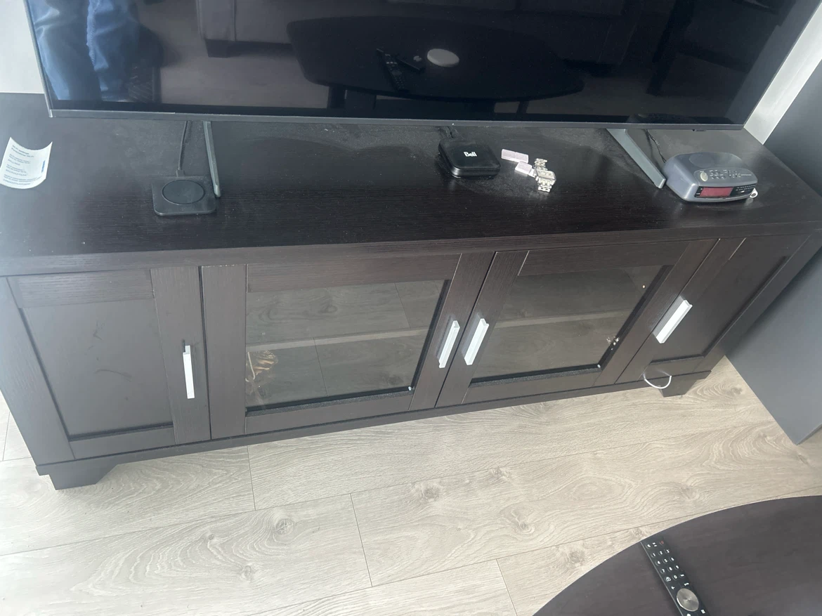 Dark brown wood grain TV stand with glass doors