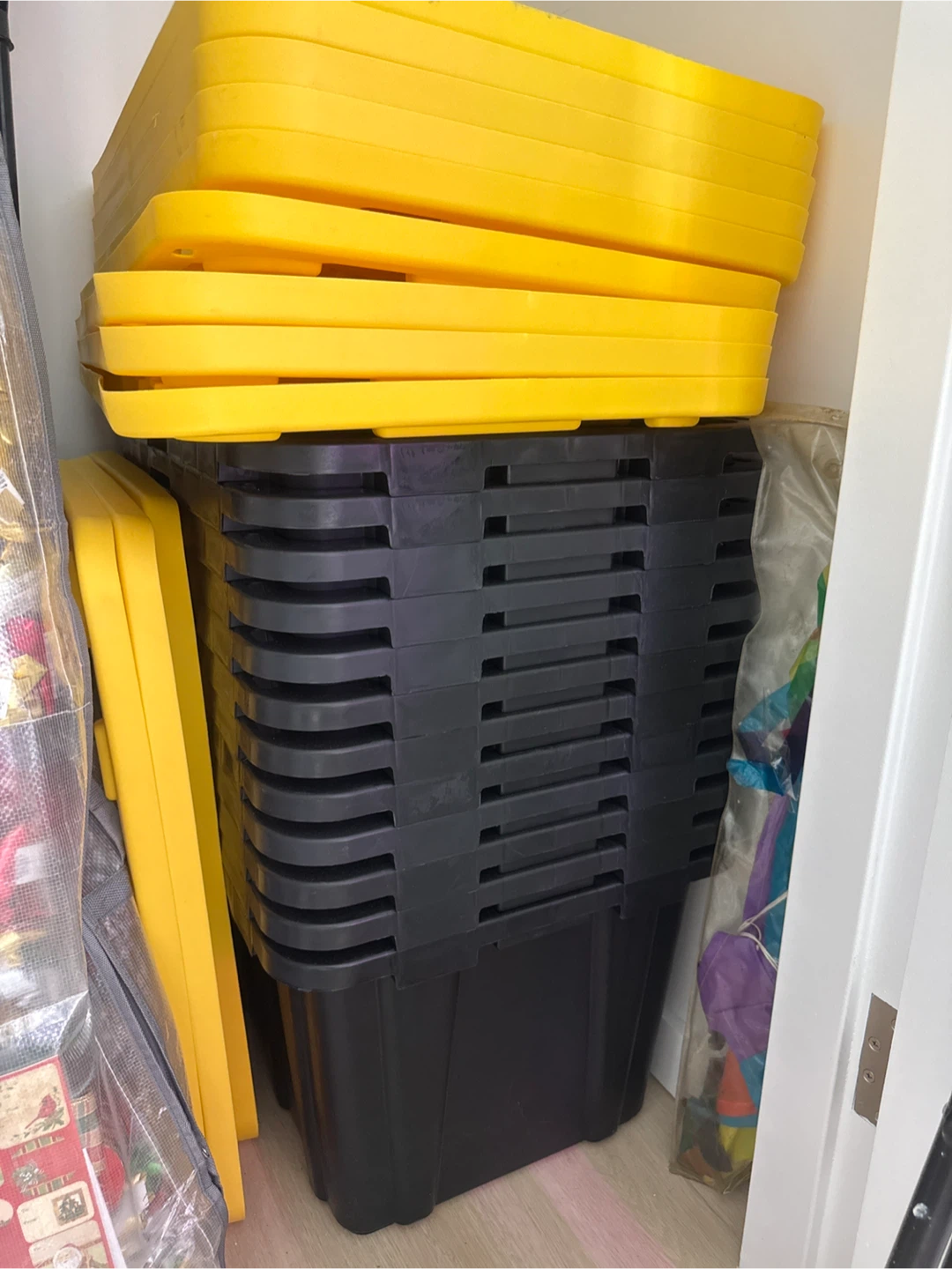 Stack of Black Storage Bins with Yellow Lids