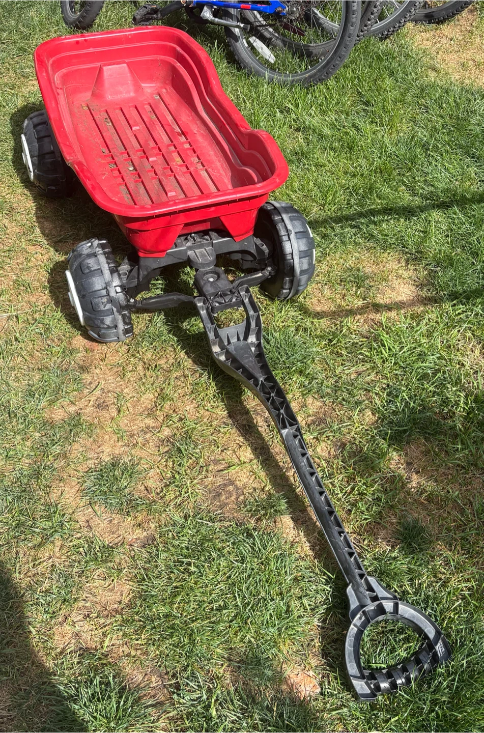 Red plastic wagon with pull handle