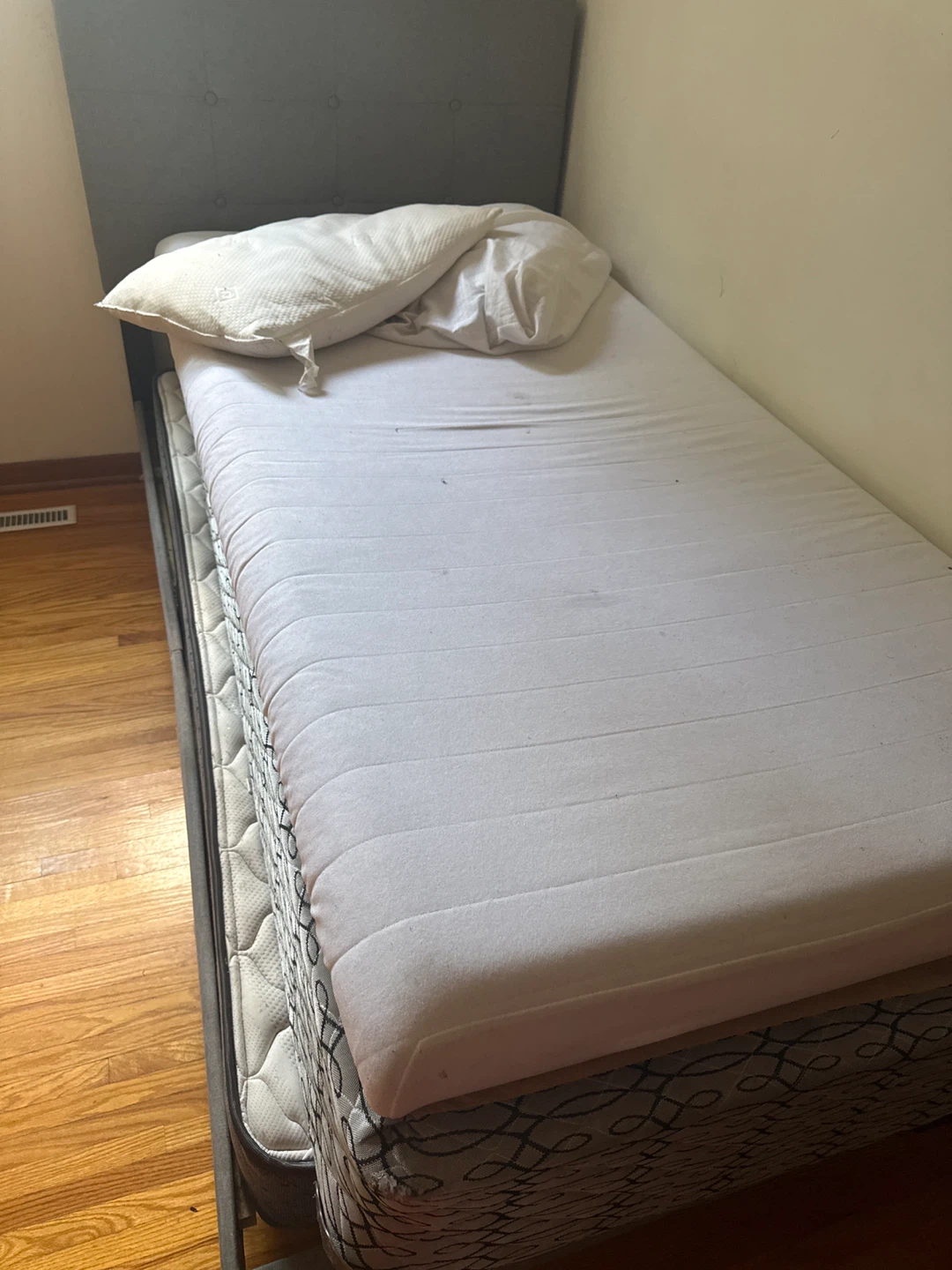 Grey twin bed frame with tufted headboard