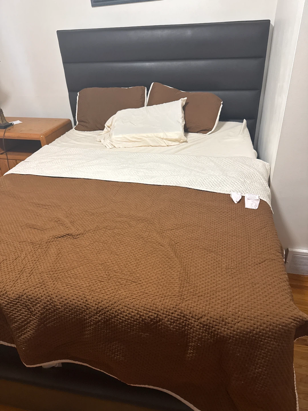 Black upholstered bed frame with headboard