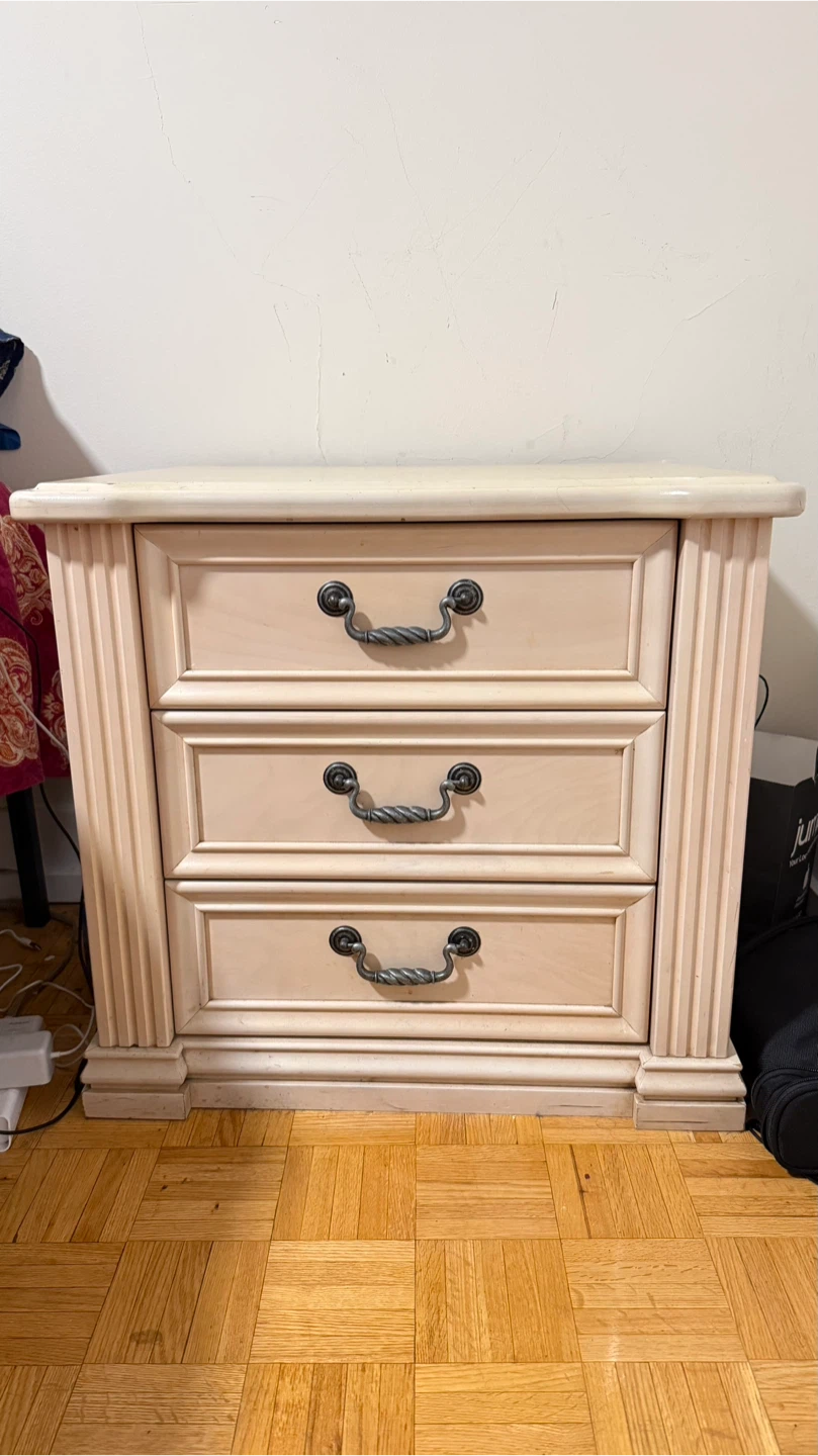 Cream wooden nightstand with three drawers
