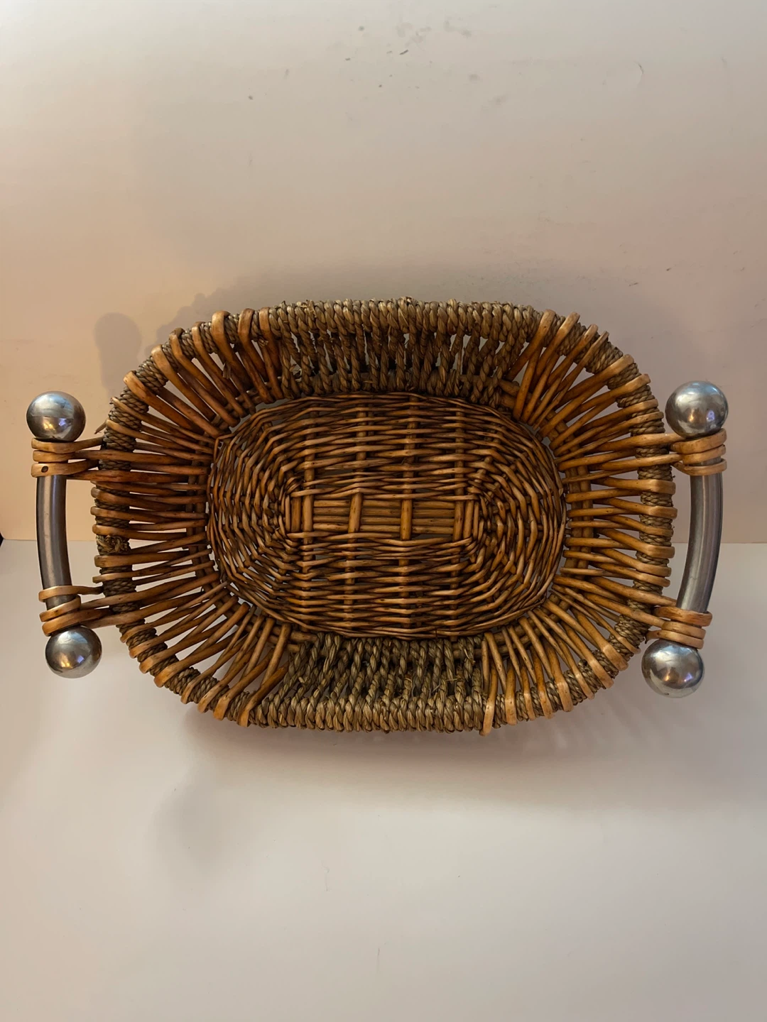 Oval wicker basket with metal handles