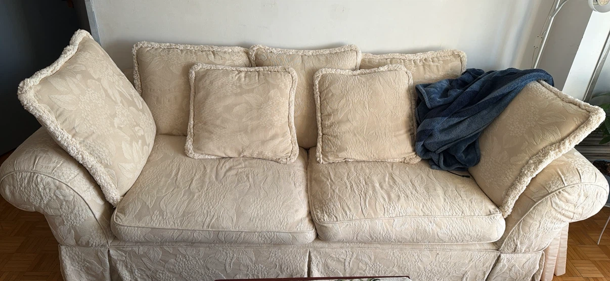 Cream floral patterned sofa with matching cushions