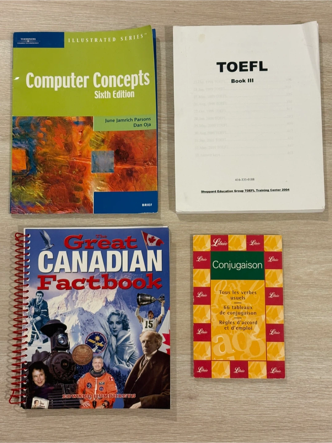 Assorted educational books and French verb guide