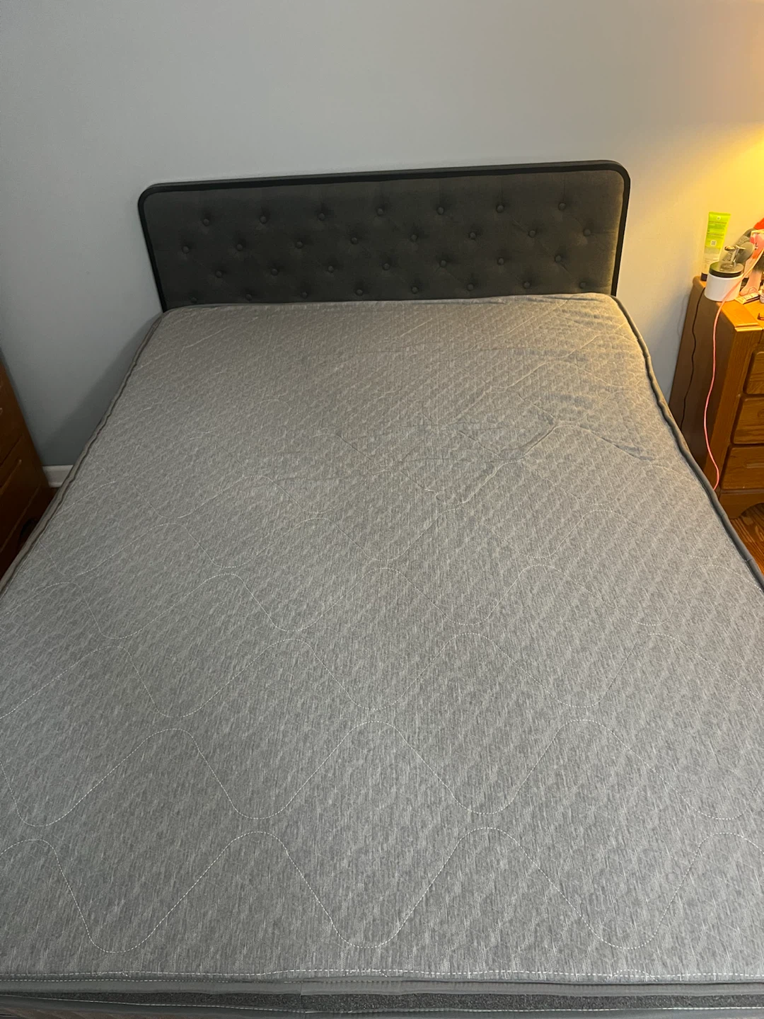 Gray upholstered bed frame with tufted  headboard