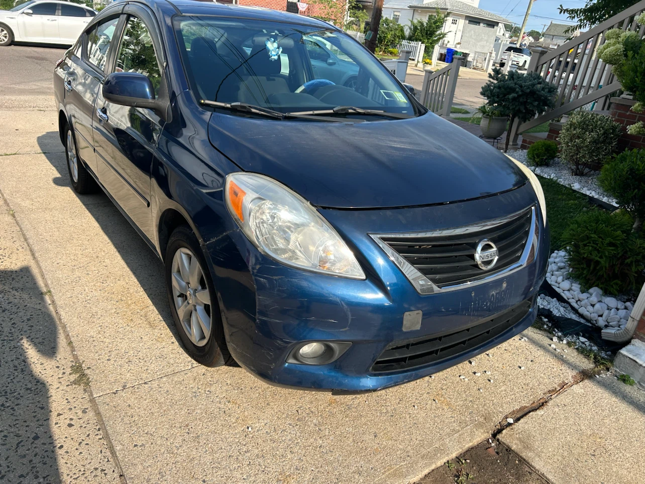 Blue Nissan Versa SL Sedan