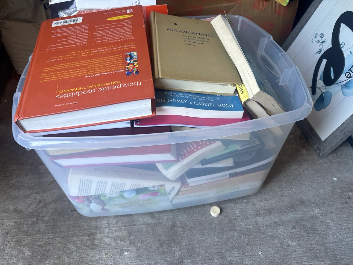 Bin of books and bin of vhs tapes must take both
