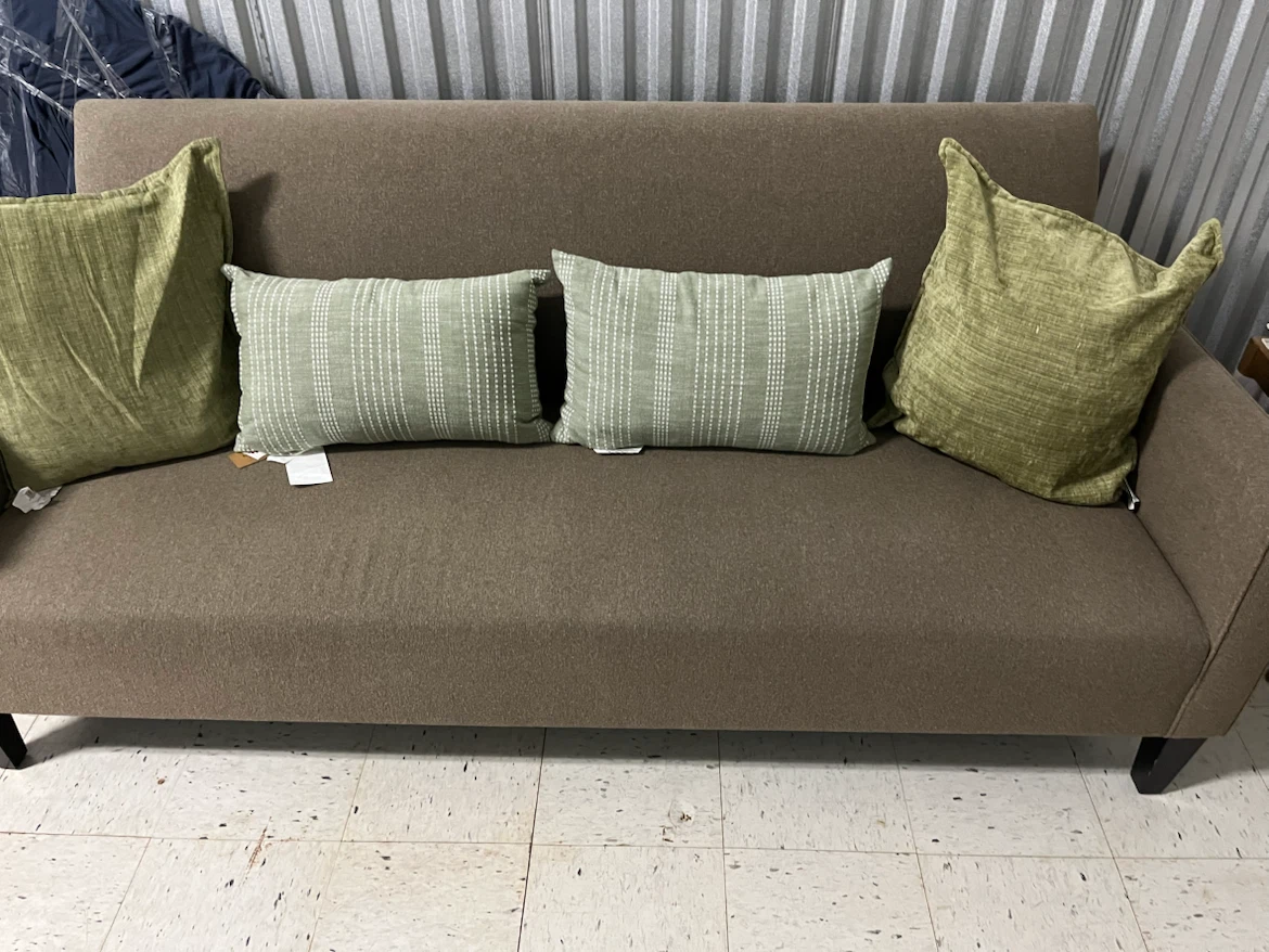Brown Loveseat Sofa with Green Pillows