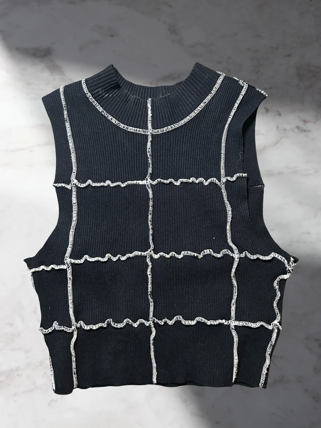 Black sleeveless top with contrast stitching