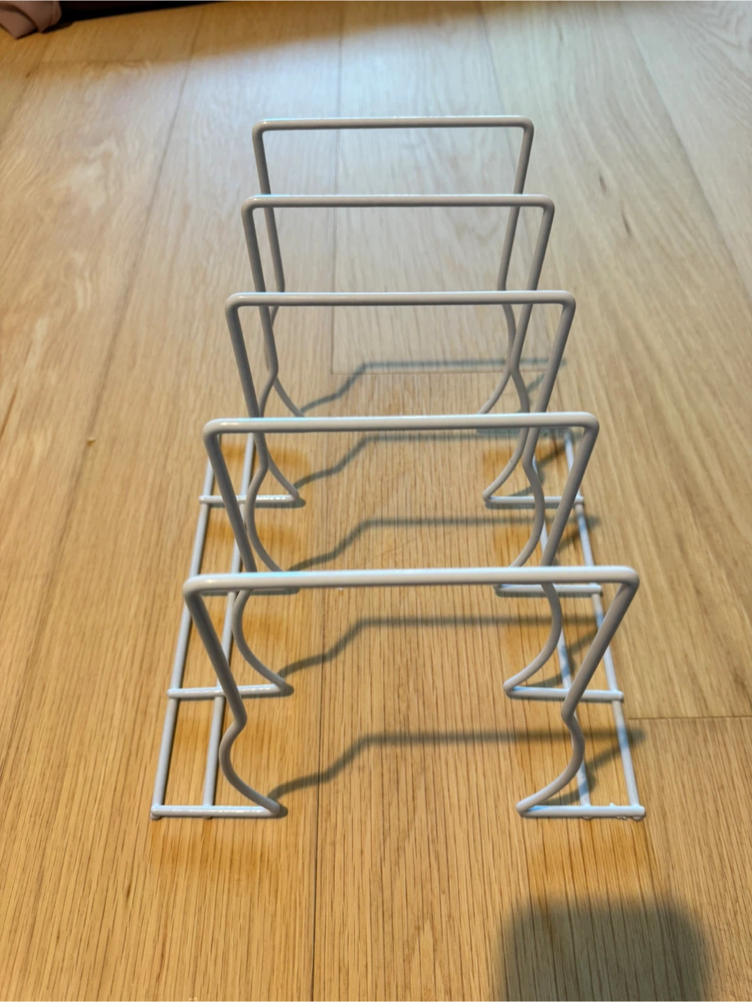 White metal pot lid and pan organizer rack