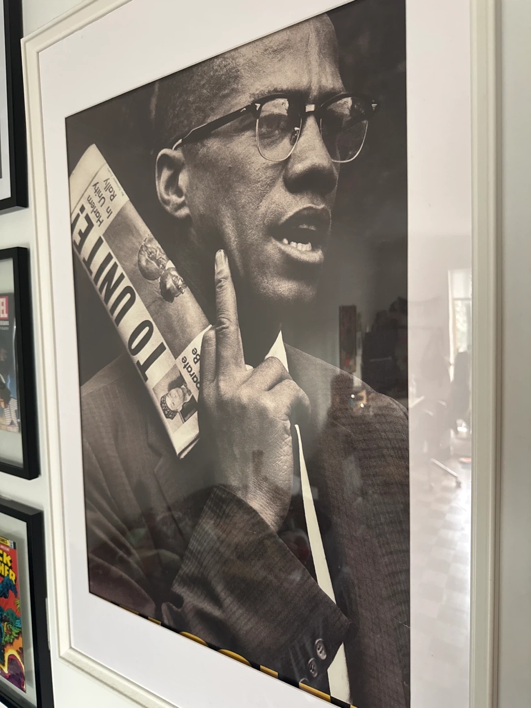 Framed Print of Malcolm X Holding Newspaper