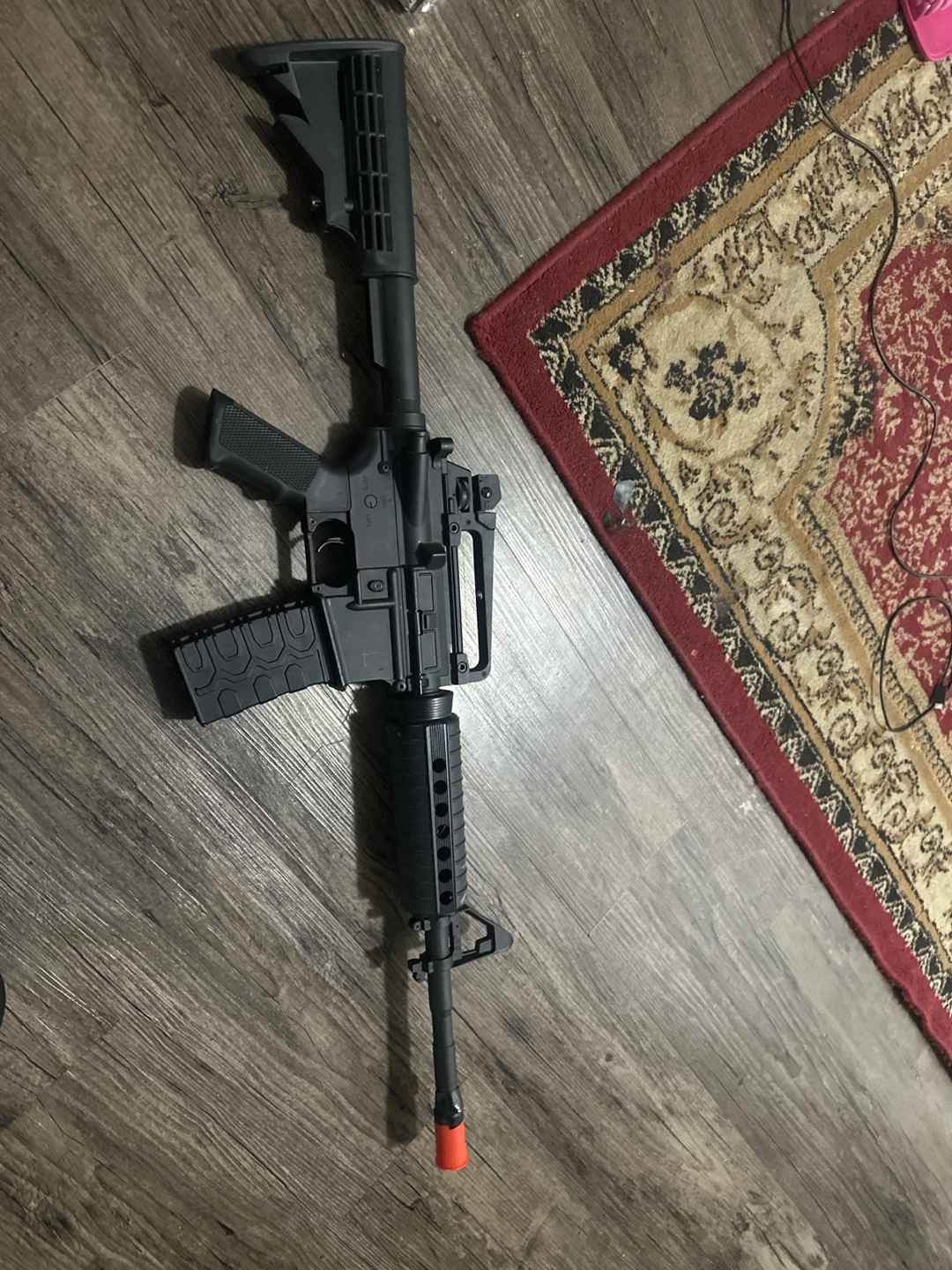 Black Airsoft Rifle with Orange Tip