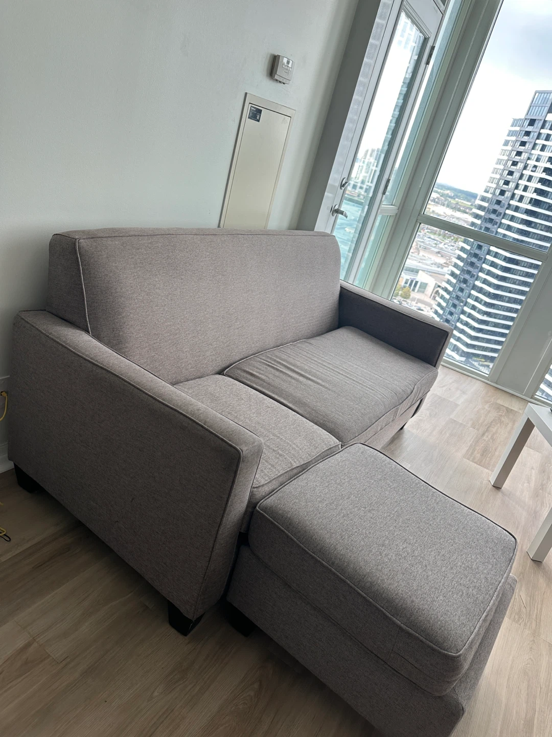 Grey triple seat with Ottoman