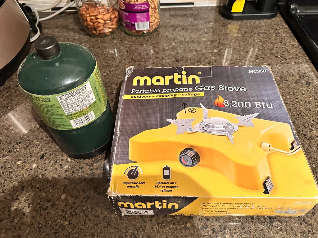 Camping burner, cooking pots, table, water tank, soap.