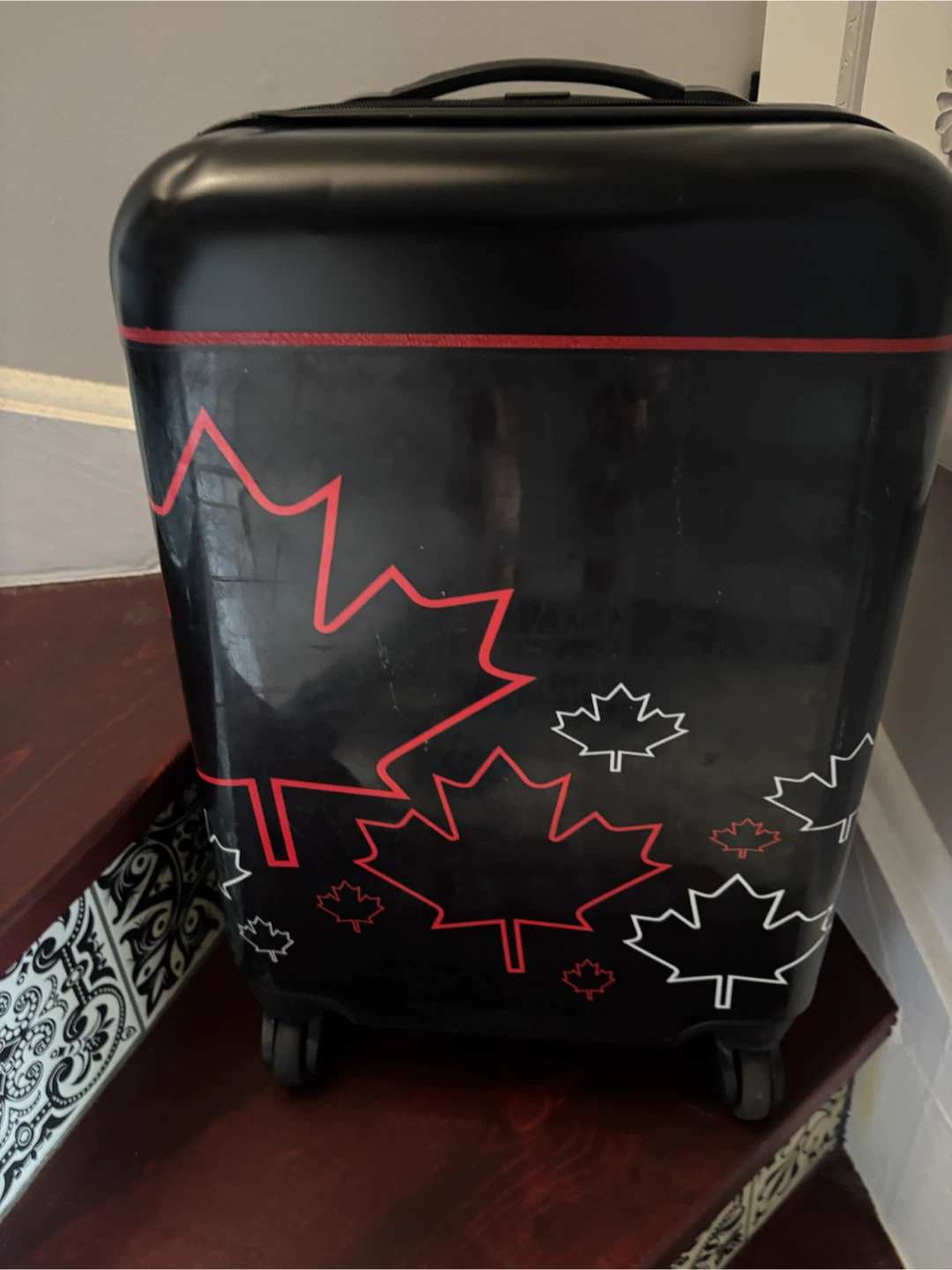 Black Carry-On Suitcase with Maple Leaf Design