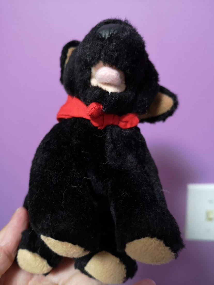 Black stuffed dog with red lips and bow