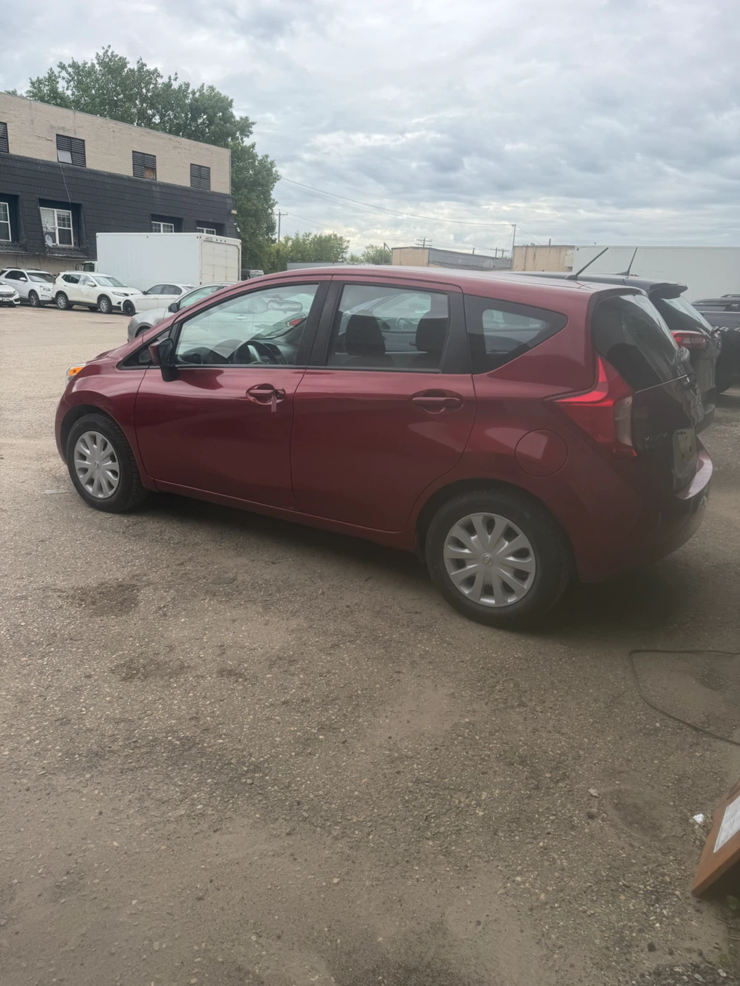 Red Nissan Versa Hatchback - photo 4