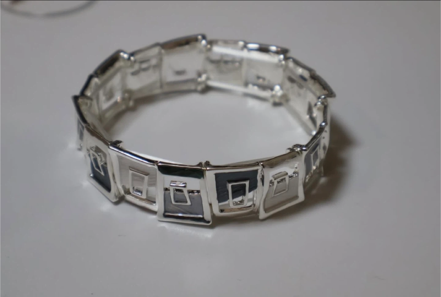 Silver tone bracelet with square design