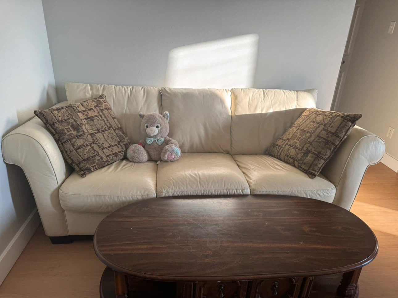 Cream Leather Sofa with Decorative Pillows