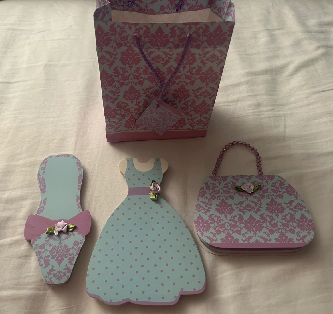 A set of decorative, die-cut paper pads: dress/shoe/handbag,