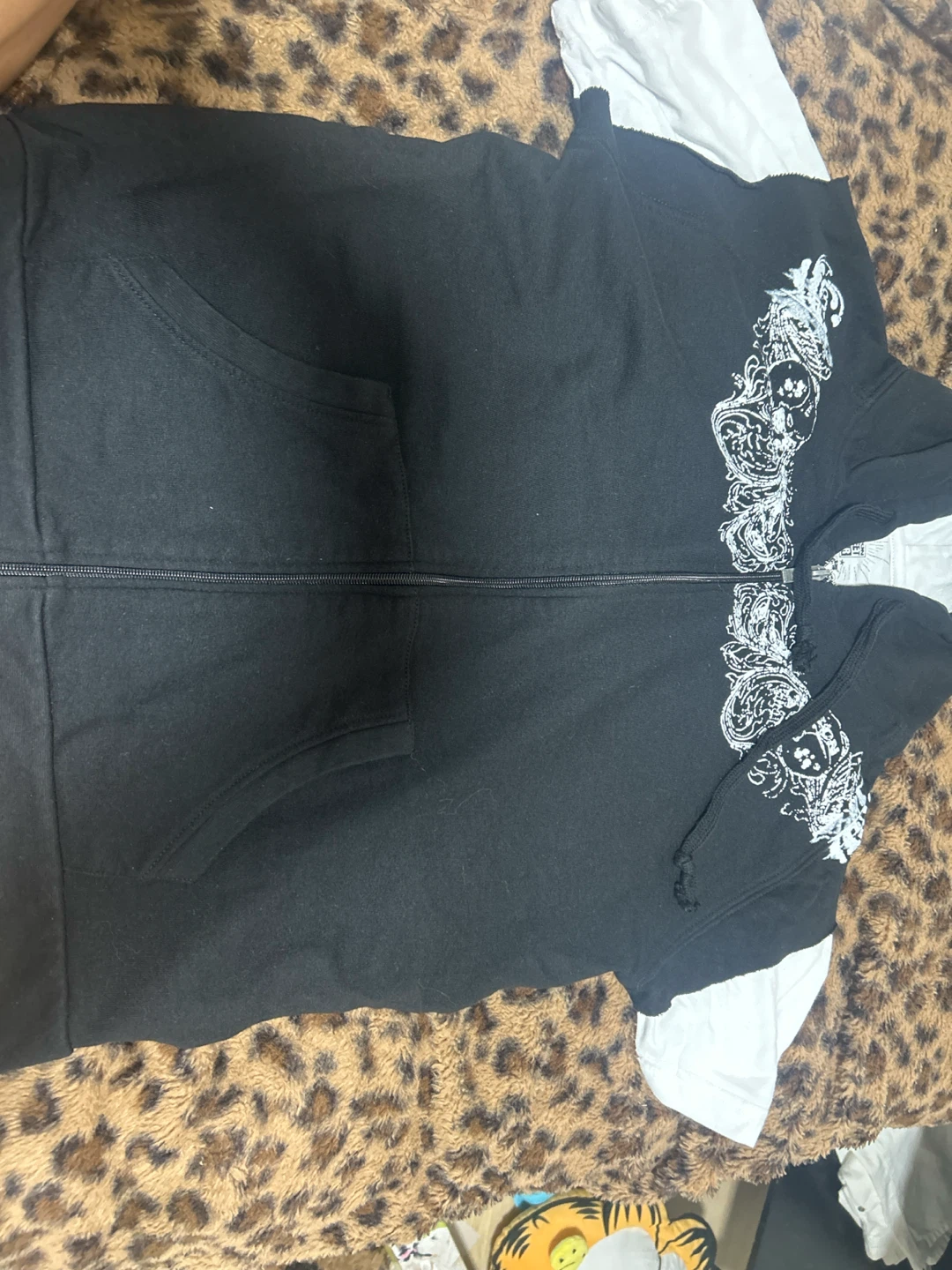 Black zip-up hoodie with white graphic details