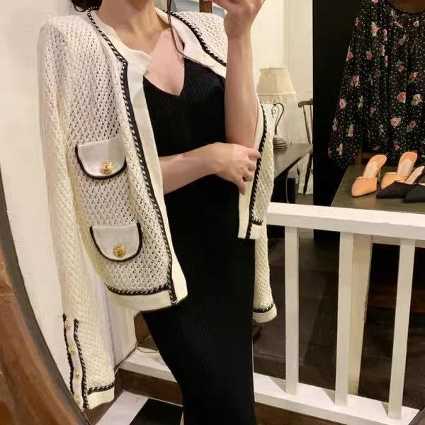 Cream knit cardigan with black trim and gold buttons