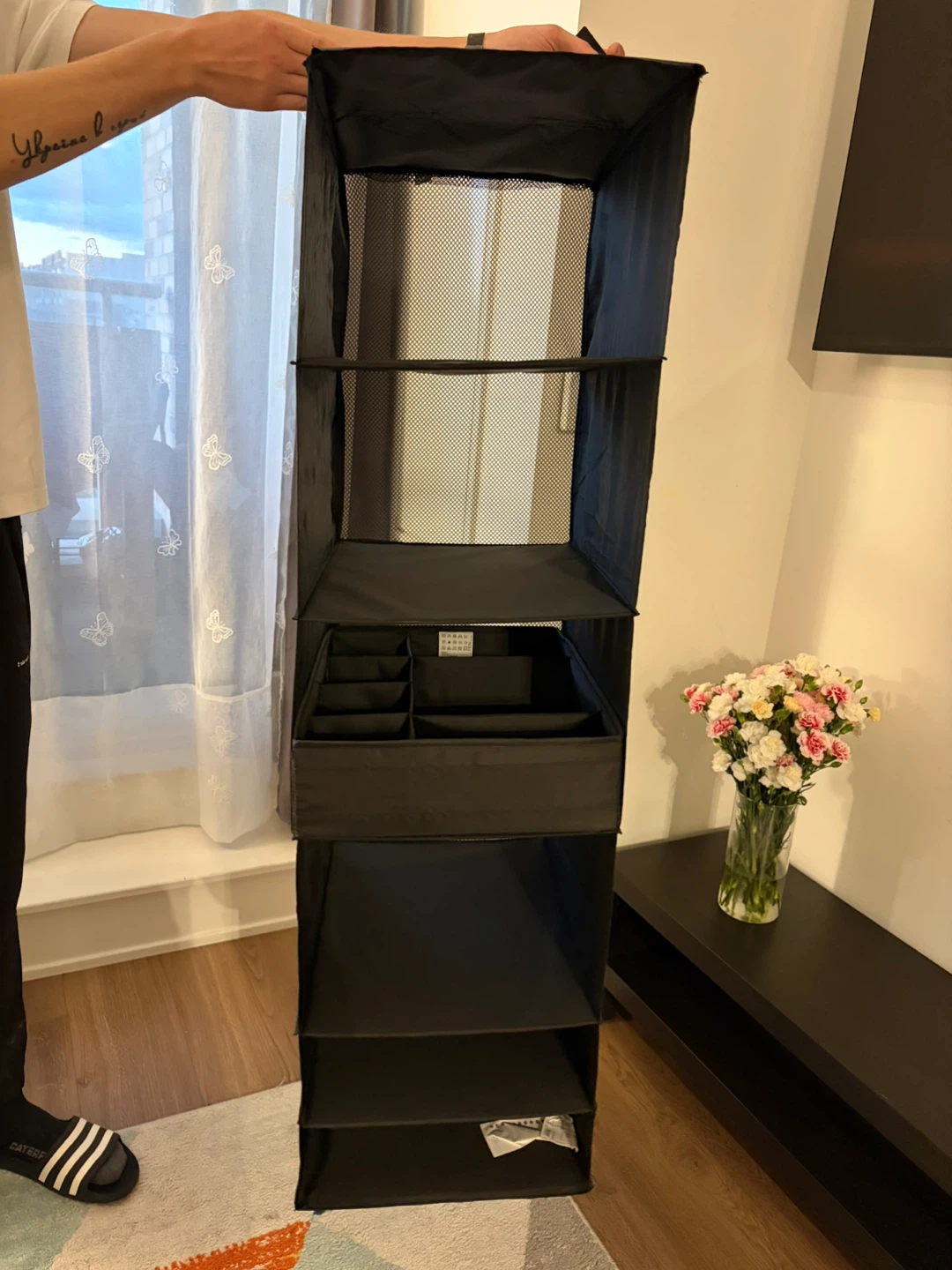 Black hanging closet organizer with shelves