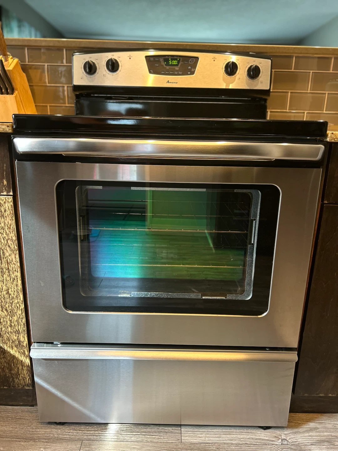 Stainless steel Amana electric range with a black glass cooktop - photo 2