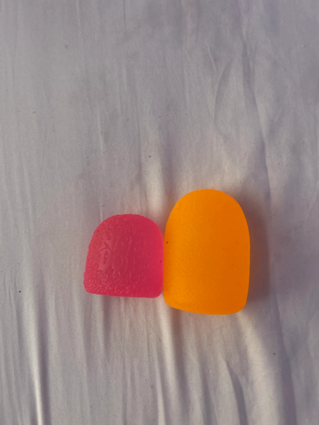 Two gumdrop squishy toys one Needoh other one is fake