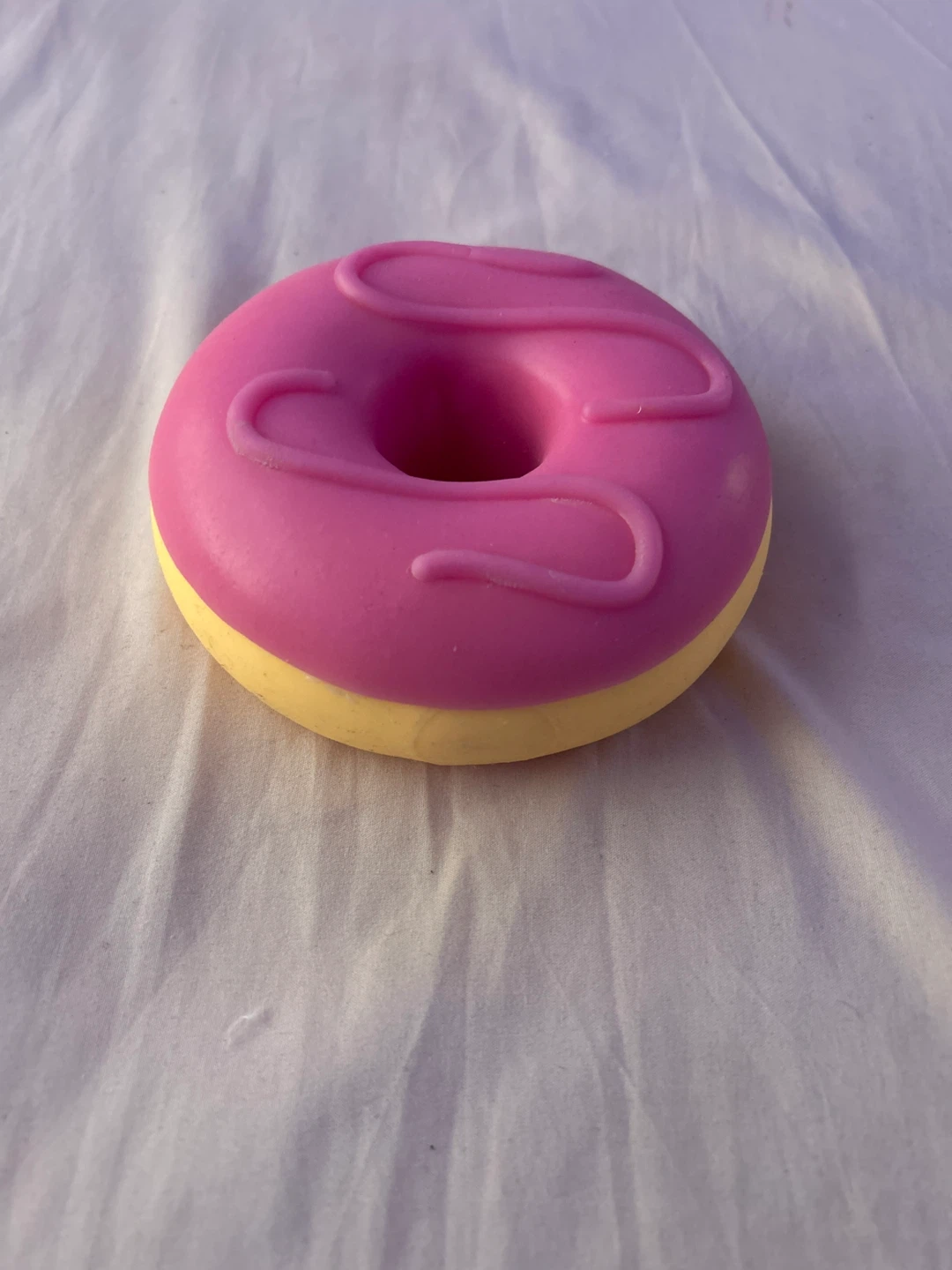 This is a jumbo pink frosted squishy doughnut