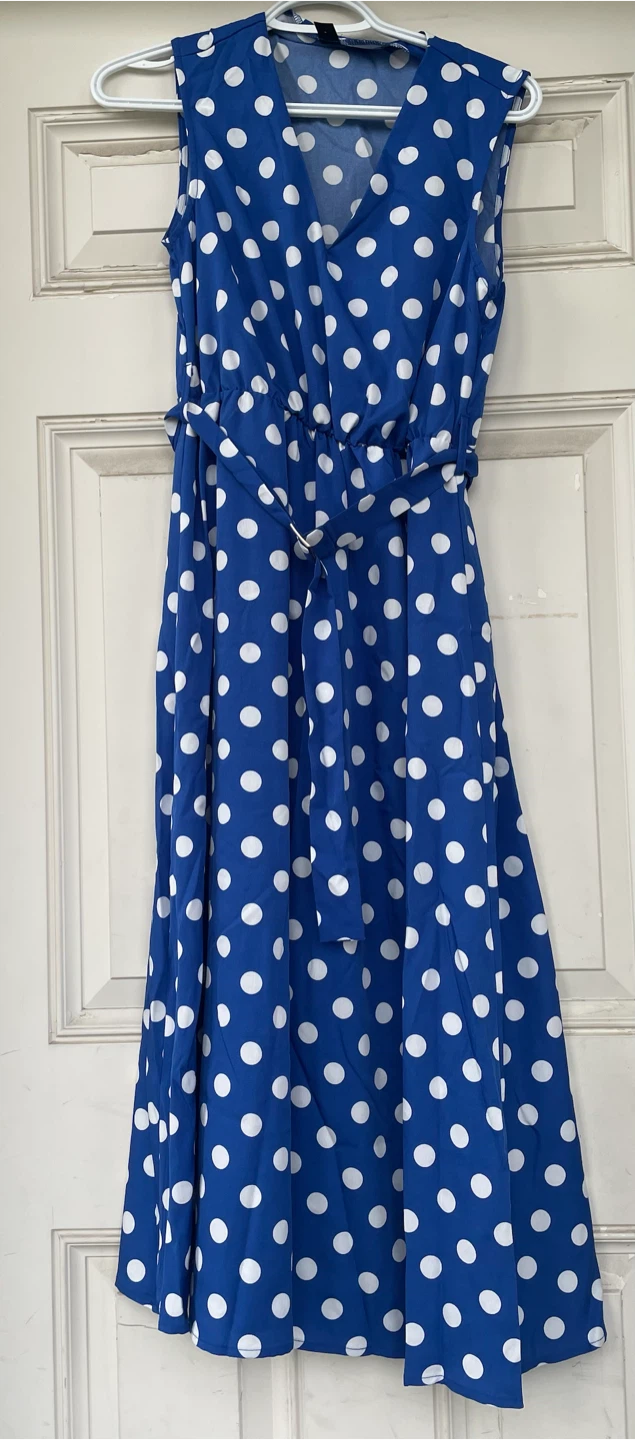 Blue v-neck dress with white polka dots.