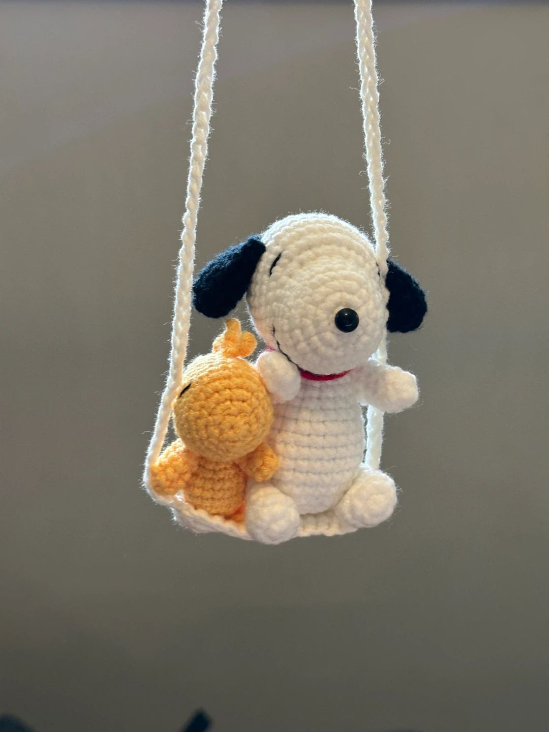 Crocheted Snoopy and Woodstock on a Swing
