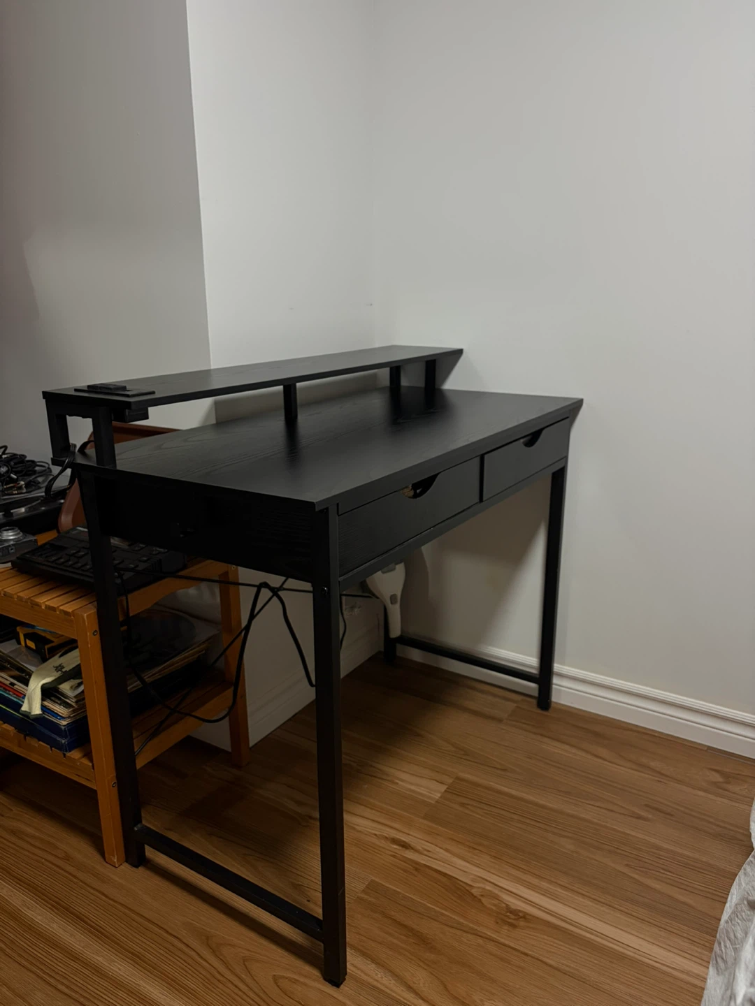 Black computer desk with shelf and power outlets