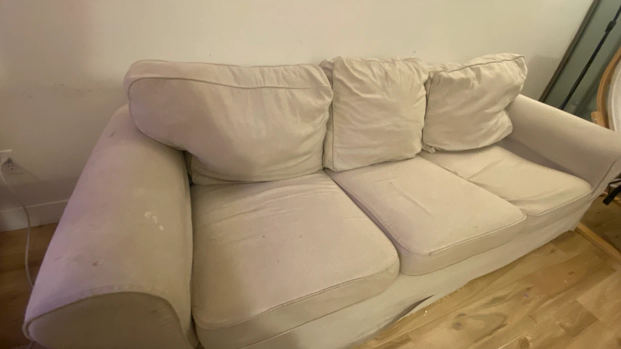 Beige three-seater sofa