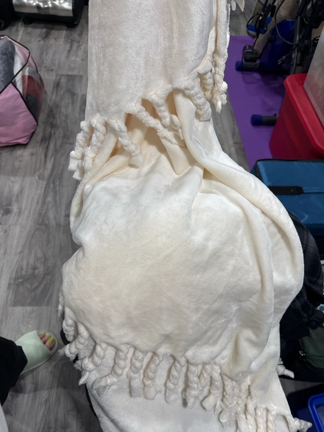 Cream coloured throw blanket with braided fringe