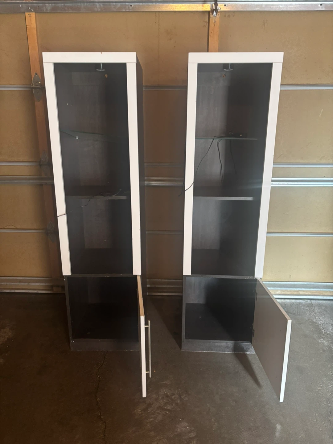 Two tall display cabinets with doors