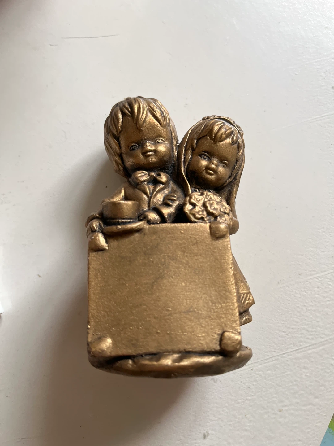 Brass-tone figurine of children