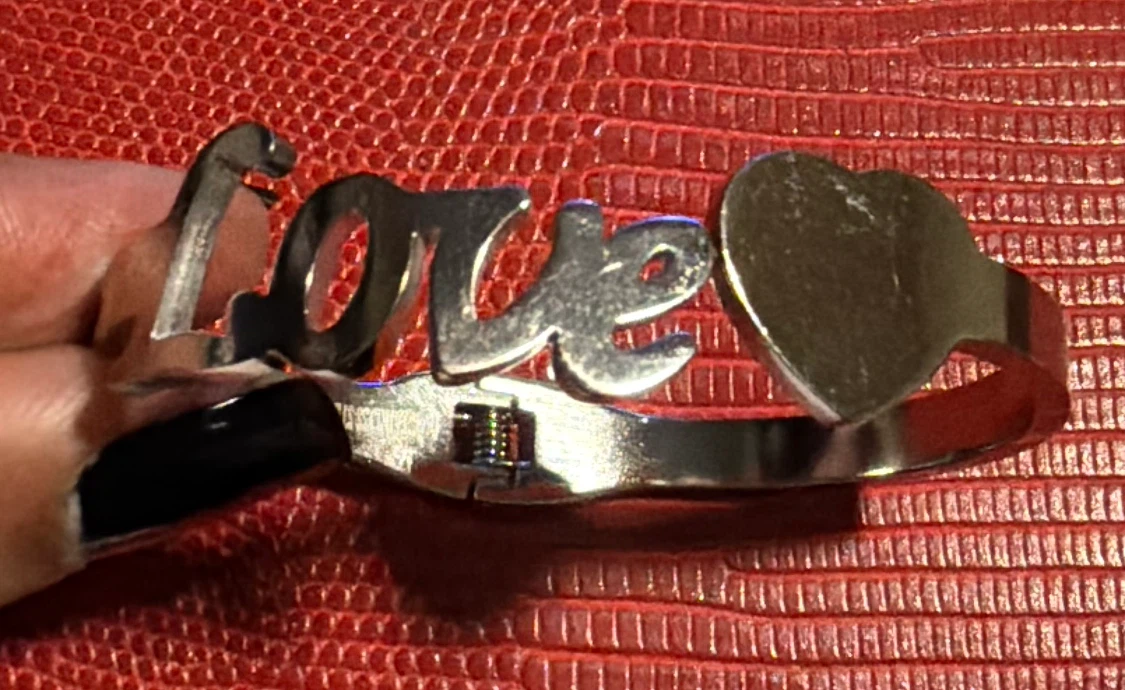 Silver tone "love" cuff bracelet with heart accent