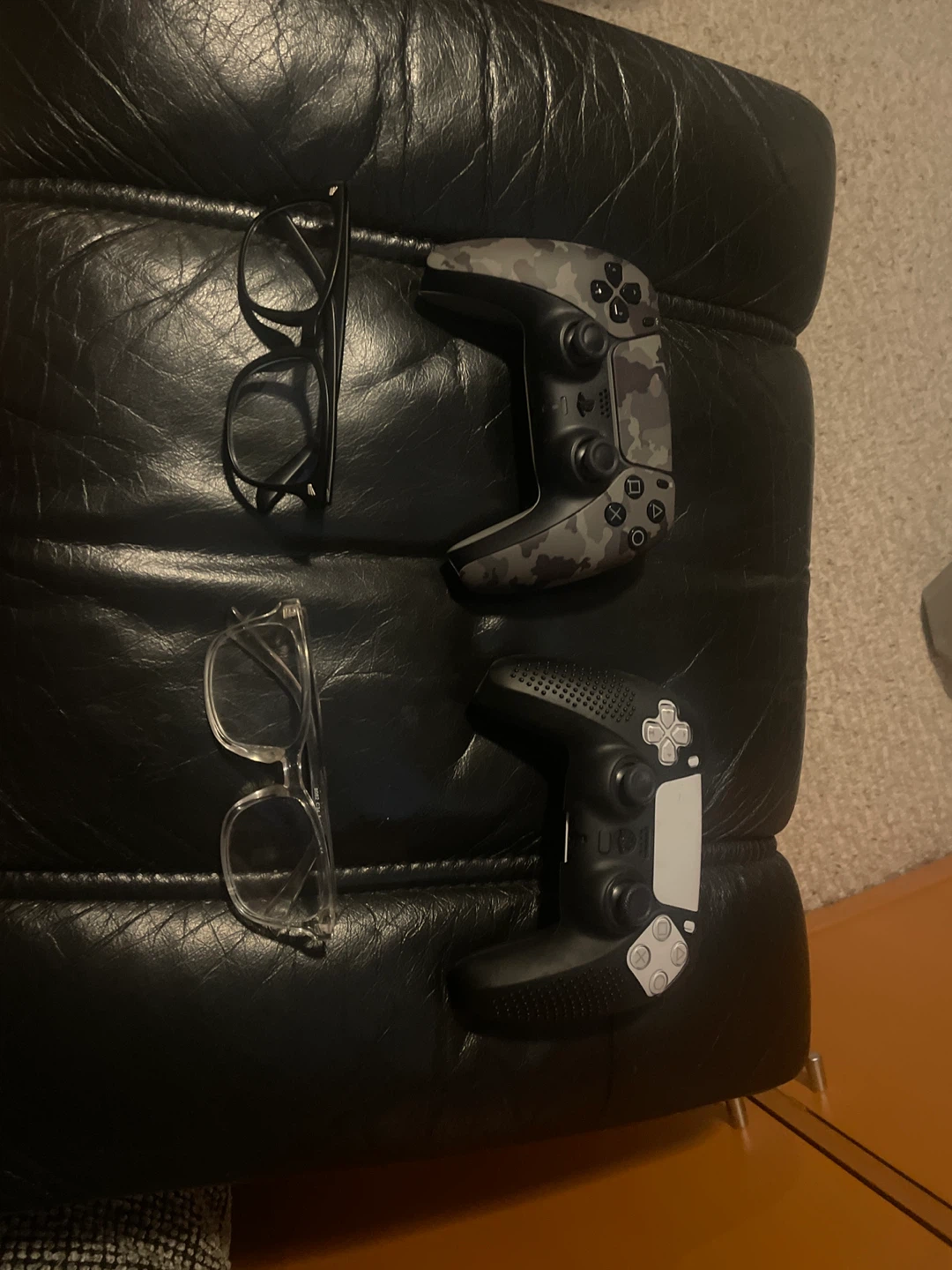 Two ps5 controllers and two blue light glasses
