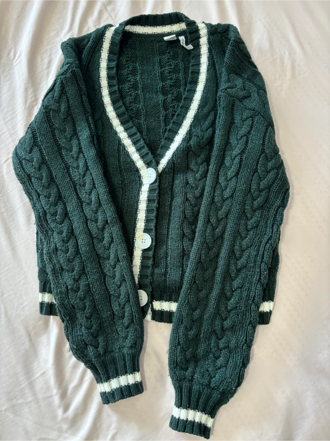 Simon’s green cable knit cardigan