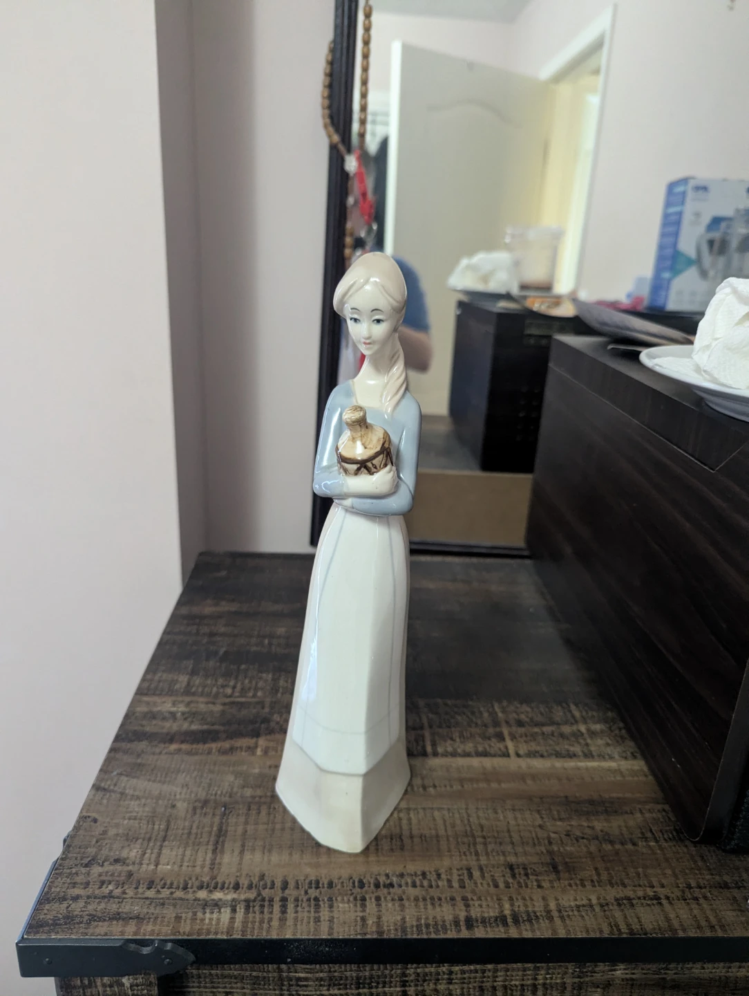 Figurine of a woman holding a pot