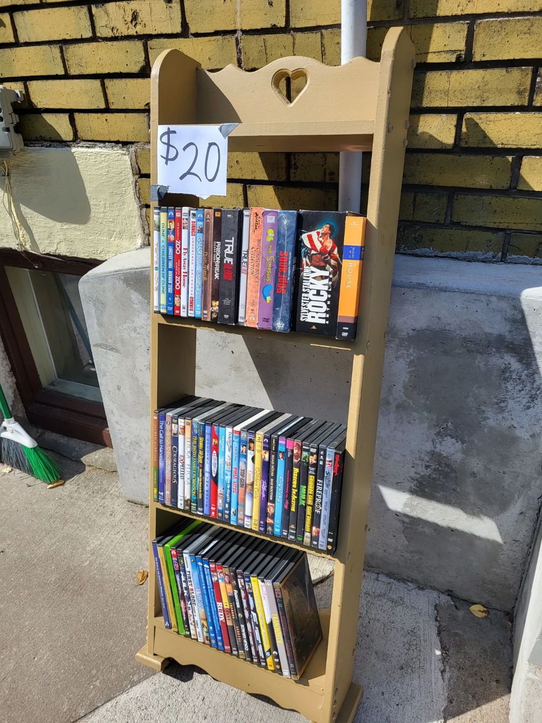 Collection of DVDs for Sale includes stand