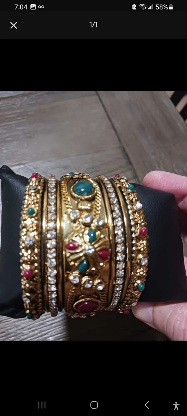 Gold coloured bangles with green and red stones