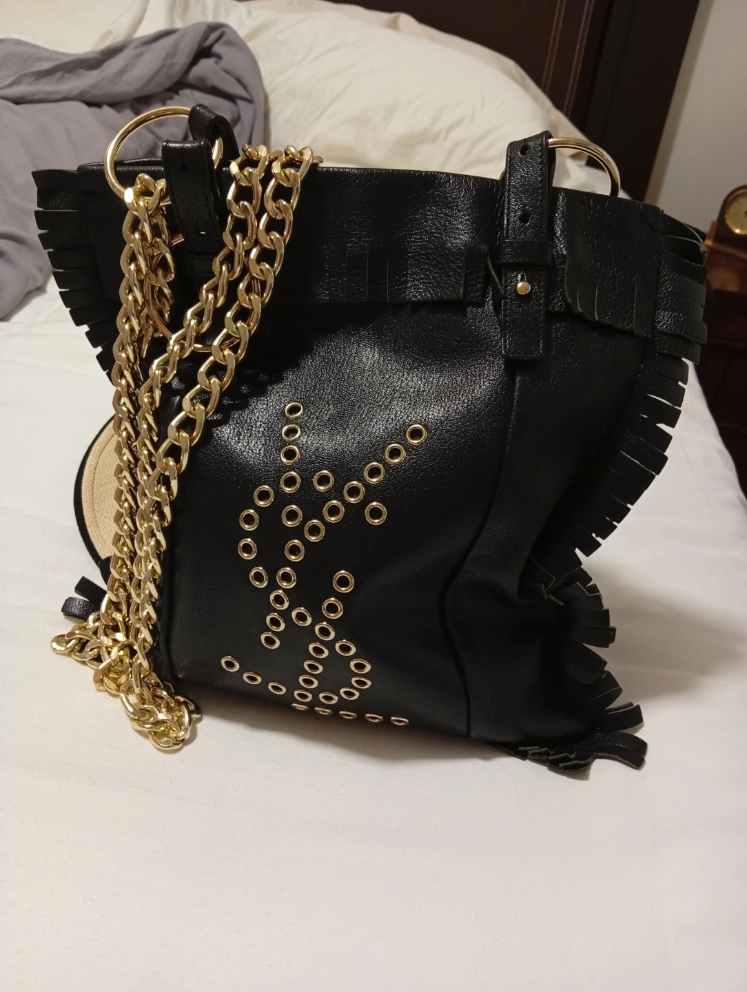 Black leather shoulder bag with gold chain and fringe