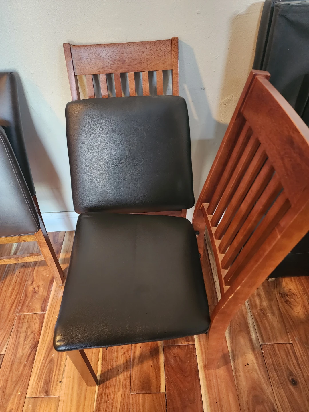 Two Wooden Folding Dining Chairs with Black Padded Seats