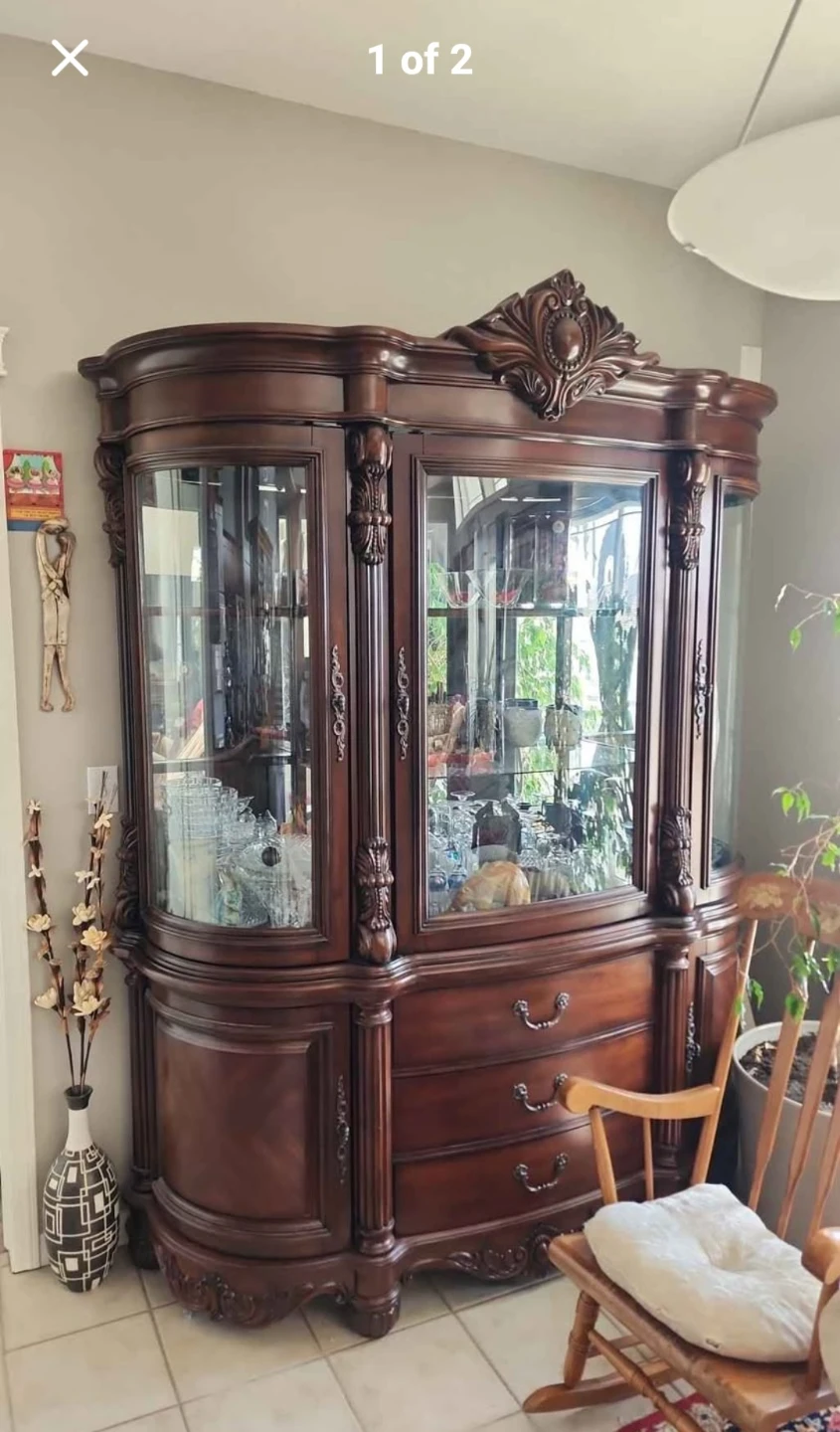 Wooden curio cabinet with glass doors and drawers