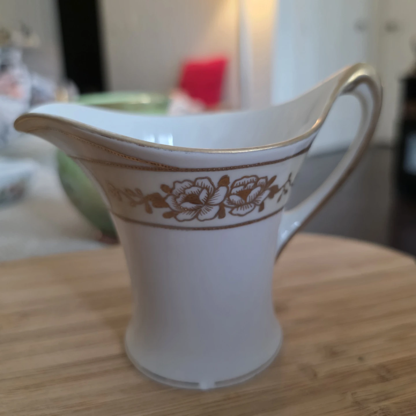 White porcelain creamer with gold trim