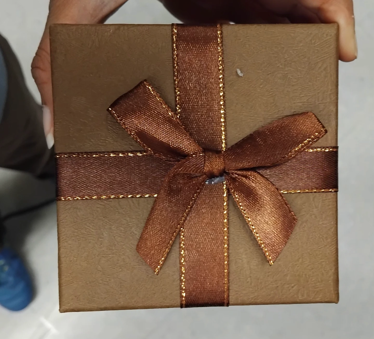 Small brown gift box with ribbon