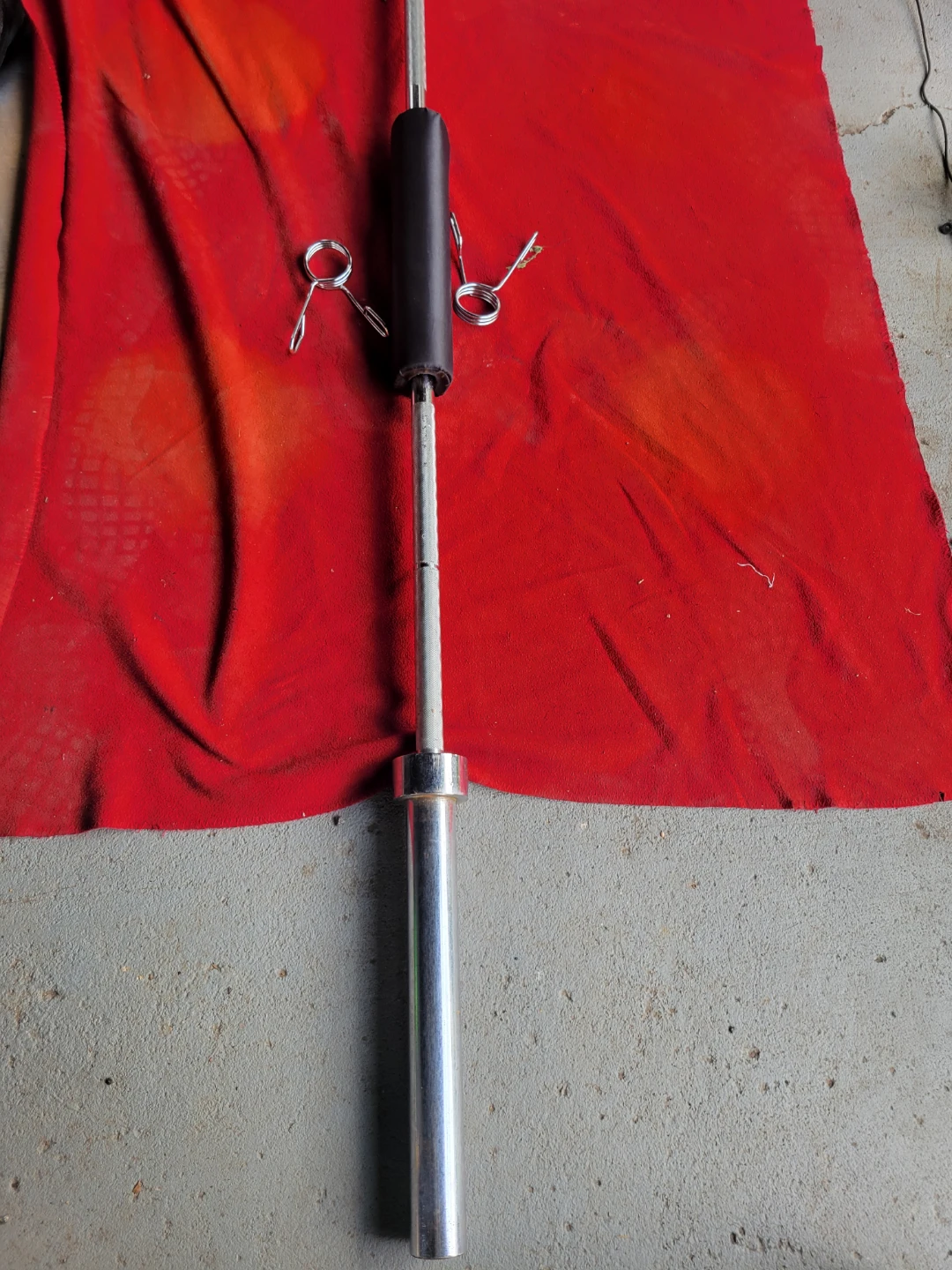 OLYMPIC 7' BAR.   45LBs WITH CLIPS AND NECK PAD.